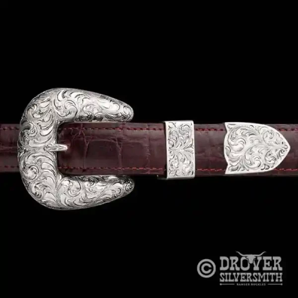 Crafted with precision and passion,  The Homesteader Sterling Silver Belt features a solid rustic charm with a hand engraved base and copper flowers in the buckle, tool and tip. Add a second loop for a ranger buckle set now!